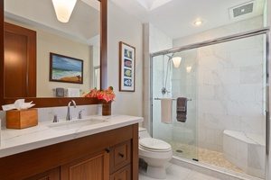 Unwind in this spa-like bathroom with marble shower, soaking tub, and warm wood vanity creating your private sanctuary.