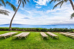 Relax in a lounge chair on the lawn at Mahana 1119 where the waves are just steps away.