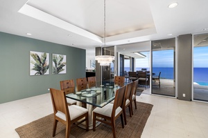 Gather around the elegant glass dining table with ocean breezes flowing through sliding doors to your private terrace.