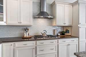 The countertop cooker takes center stage amidst a plethora of storage cabinets, combining practicality and functionality in the kitchen.