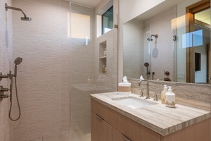 Unwind in your spa-like bathroom featuring a luxurious walk-in shower and elegant marble vanity with premium amenities.