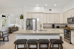 The kitchen’s spacious island and bar stools are perfect for casual meals or chatting over coffee.