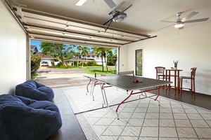 Your private game room opens to tropical views, featuring table tennis and cozy seating for endless entertainment.