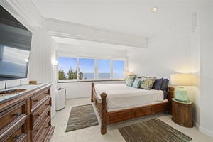 This inviting suite includes a king bed and serene windows overlooking the ocean.