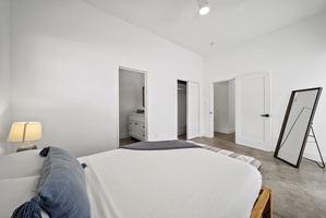 The guest suite downstairs features a plush queen-sized bed for a restful night.