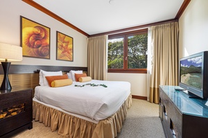 Your serene retreat features a plush bed dressed in crisp linens, warm wood accents, and garden views framed by elegant curtains. Entertainment awaits with a flat-screen TV.