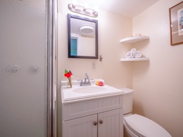 Your private bathroom features fresh towels, thoughtful touches like flowers, and everything needed for a comfortable stay.