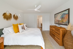 Spacious primary suite with King bed and warm wood furnishings.