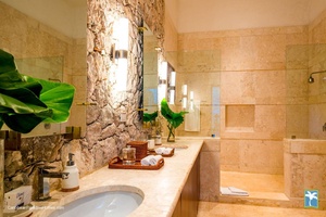 Full ensuite bathroom with a stone accent wall.