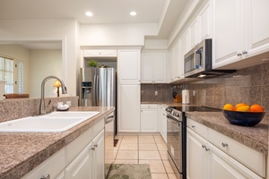 Your gourmet kitchen awaits with granite counters, stainless steel appliances, and everything you need to create memorable meals together.