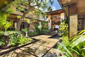 A welcoming courtyard framed by lush gardens sets the tone for a peaceful island retreat.