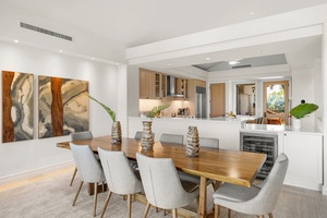 The open kitchen flows seamlessly into your dining space where warm wood meets modern elegance.