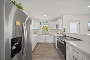 Crisp and clean kitchen with ample appliances and tools for crafting delightful meals