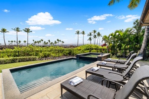 Lounge by the pool surrounded by lush tropical foliage and sweeping mountain views.