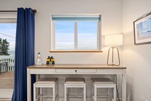 Your coastal workspace awaits with a charming nautical desk perfect for planning adventures or catching up on emails while enjoying sea breezes.