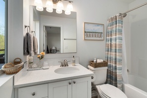 Enjoy the convenience of the shared full bathroom featuring dual sinks and a colorful, functional design—ideal for shared use.