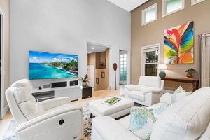 Bright and breezy living room with a smart TV and cozy seating.