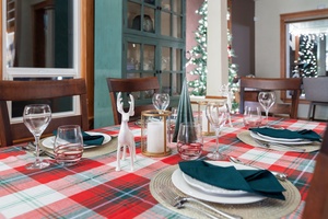 Beautiful table settings with reindeer accents and holiday candles, ready for celebration.