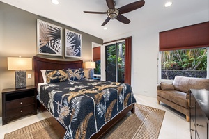 Unwind in your tropical-themed bedroom featuring a ceiling fan, plush furnishings, and serene garden views through your private windows.