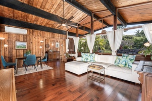 Gather in your tropical retreat where wood meets fresh breezes, surrounded by lush garden views and modern comfort.