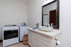 Shared bath with tubshower combo and washer and dryer.