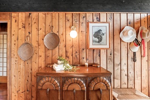 Warm wood paneling creates a cozy retreat where charm meets modern comfort in your thoughtfully curated space.