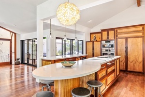 The kitchen has a warm feel with its stunning wood cabinetry.