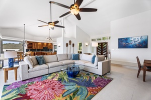 Expansive great room with seating and dining areas, ideal for entertaining guests or connecting over a sunset dinner.