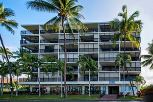 Front view of Kona Alii with lush palms and tropical flair.