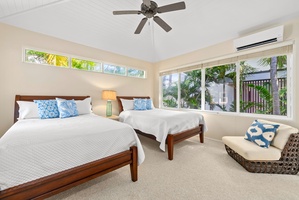 Wake up to tropical garden views in your bright bedroom with twin beds, ceiling fan, and AC for perfect comfort.