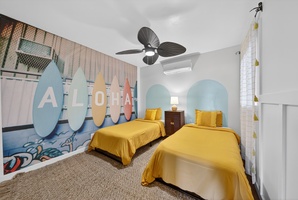Bright and cheerful twin bedroom with island-inspired decor, perfect for a restful stay.