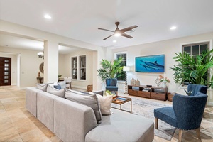 Contemporary decor and a vibrant ocean-themed artwork all around the living area..