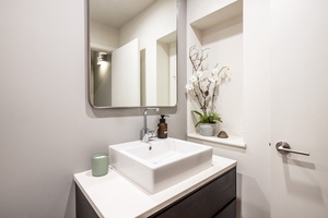 Powder room with elegant modern fixtures and stylish accents.