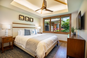 A peaceful retreat with a king-size bed, ceiling fan, and warm lighting for restful island nights.