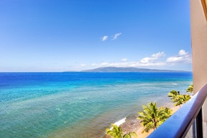 Crystal clear waters and distant islands stretch beyond the lanai at Mahana 1119.