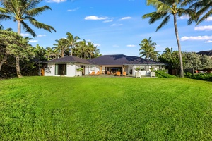 A sweeping view of the estate from the gardens reveals its graceful design along the coastline.