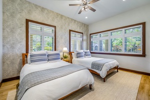 The fourth bedroom with two full-size beds and natural light.