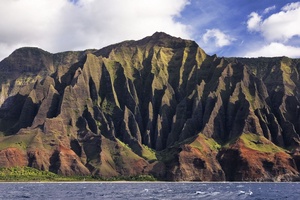 Admire the towering cliffs of the Napali Coast at sunset, a natural wonder you’ll remember forever.