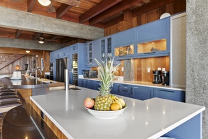 The gourmet chef's kitchen features oversized islands, custom cabinetry, premium appliances, and generous prep space designed for entertaining.