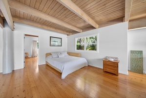 Recharge in the Pune'e in the downstairs living room with a California King bed, warm wood ceilings and garden surroundings.