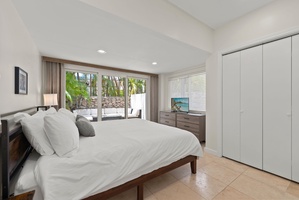 Bright guest bedroom with king bed and garden views, perfect for restful nights.