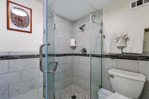 Loft bathroom with a walk-in shower in a glass enclosure