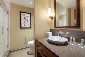 Step into your elegant bathroom featuring warm coastal touches and modern amenities for a refreshing start to your day.