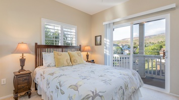 The lovely second guest bedroom with soft bedding and natural lighting.