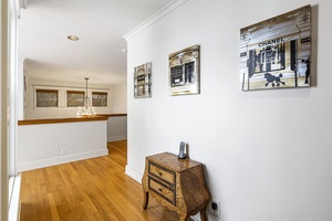 Bright hallway connects the primary suite with the rest of the upper-level spaces.