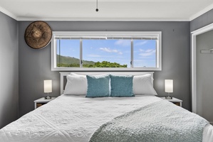 Enjoy stunning views from this spacious guest bedroom, the perfect place to start your day in paradise.