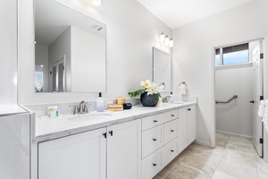 Ensuite bathroom for the primary suite with dual sink and wide vanity space.
