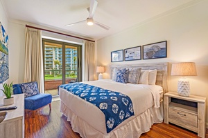 Primary bedroom at Honua Kai Konea 206 opens to lanai and features elegant island décor.
