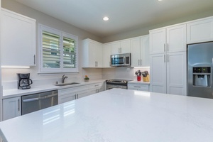 Kitchen has quartz countertops and stainless steel appliances