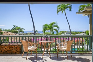 Take a step out of the primary bedroom to enjoy this cheerful seating for two, which overlooks the pool and spa